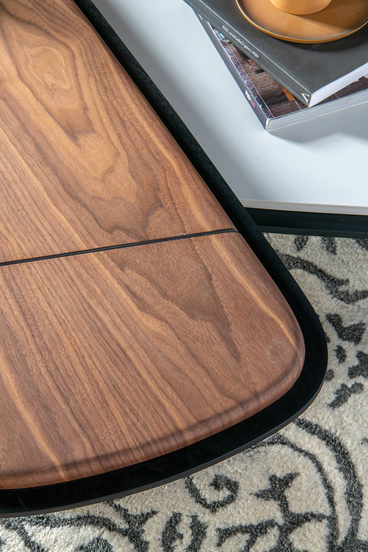 Close-up of the black walnut veneer tabletop showing wood grain texture.