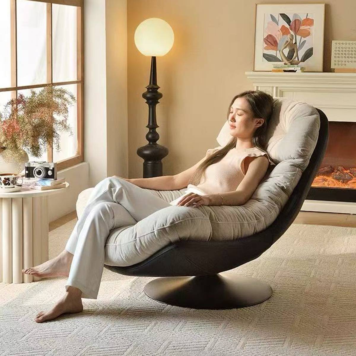 Woman relaxing in the white swivel lounge chair