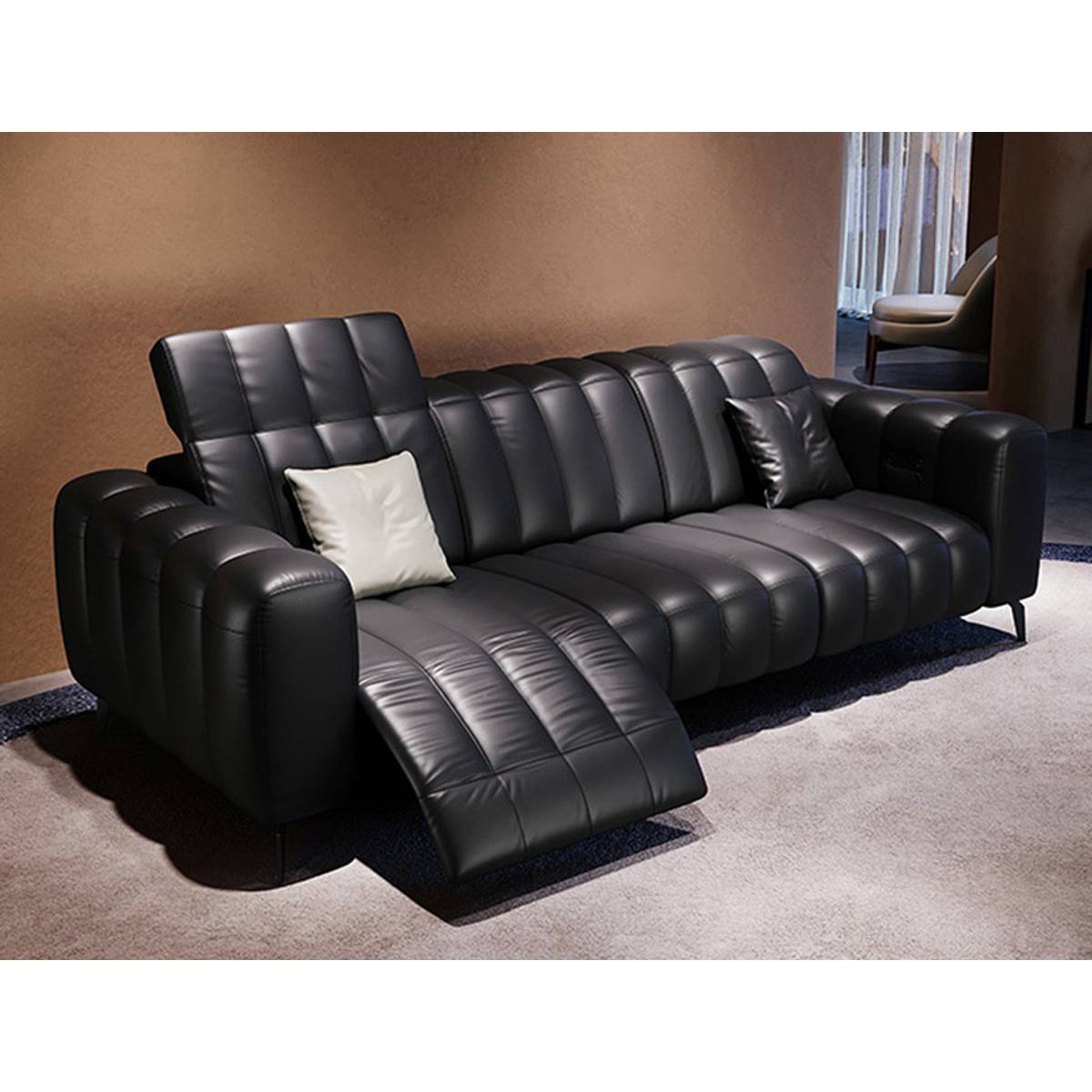 Side view of black leather sofa showing reclining mechanism