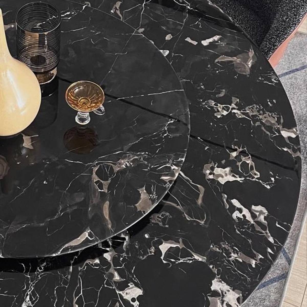 Close-up detail of the Black Rose marble surface showing the stone texture and rotating tray