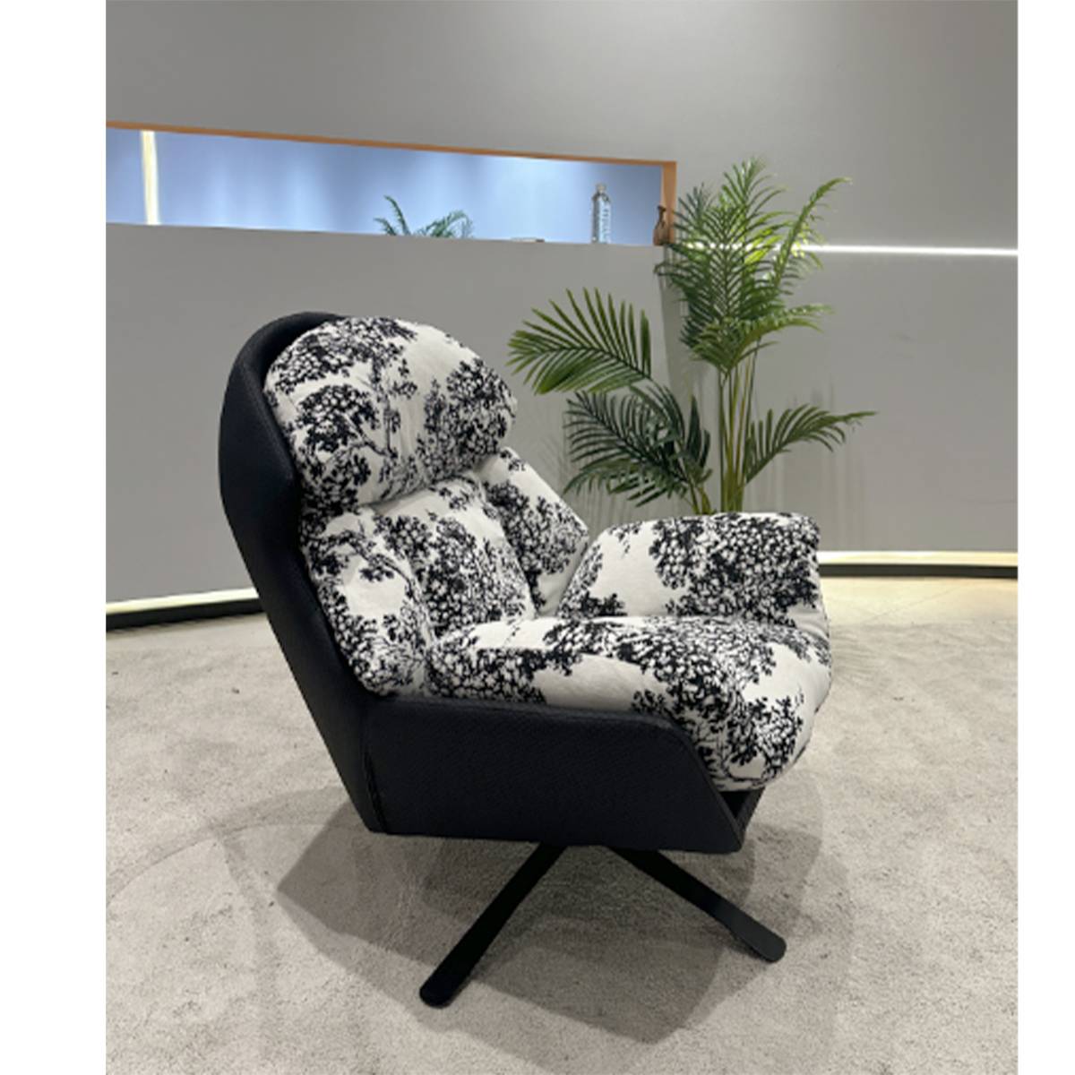 Side profile view of the lounge chair showing the swivel base