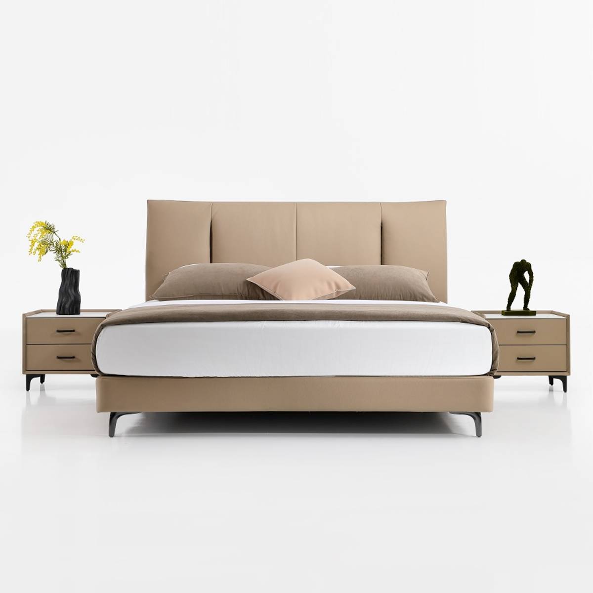 Front view of the beige upholstered bed showing the headboard and bedding arrangement