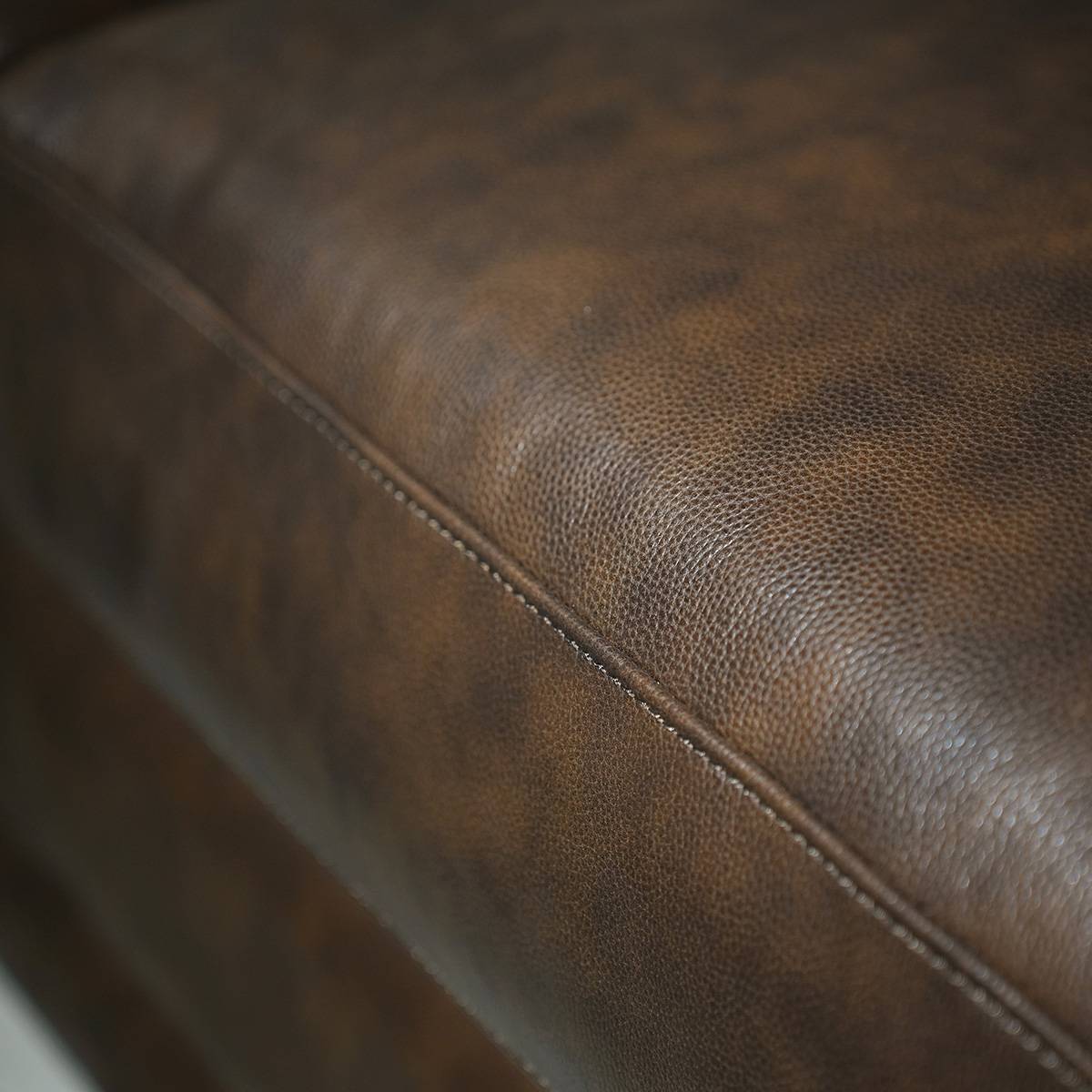 Close-up of brown leather texture and stitching