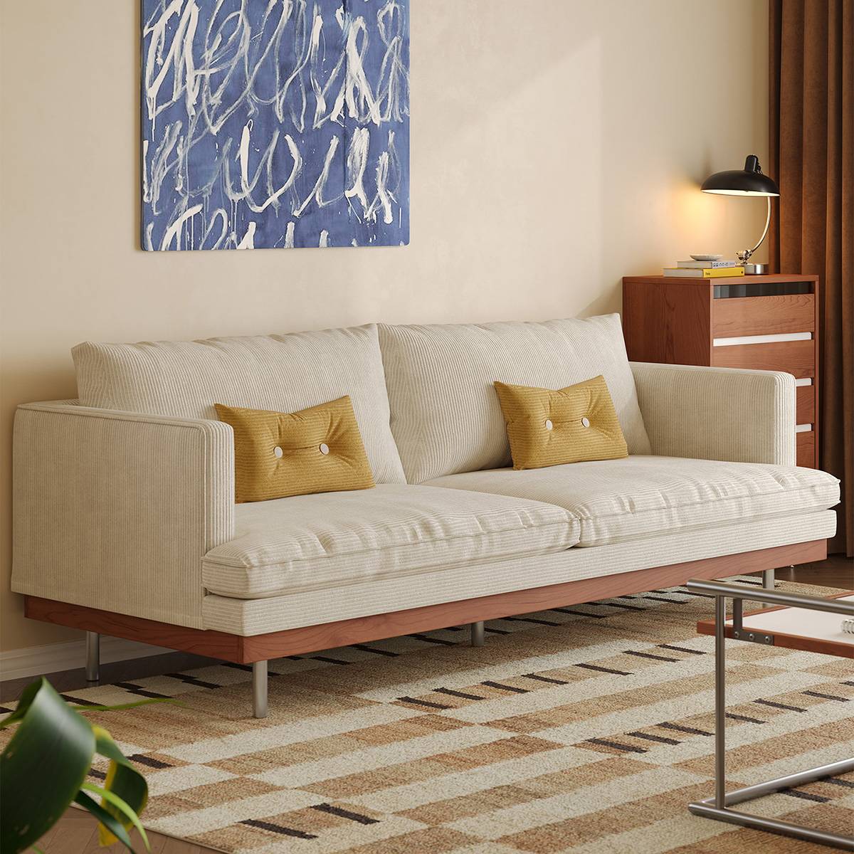 Cream white corduroy sofa with yellow pillows in a living room setting
