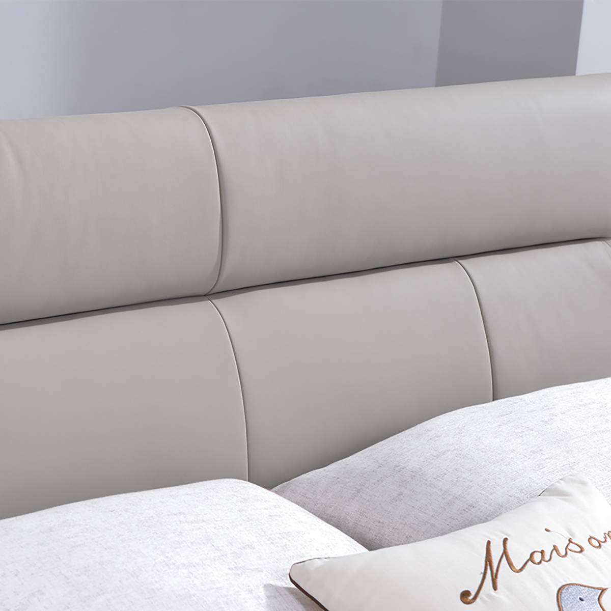 Close-up detail of the tufted leather headboard