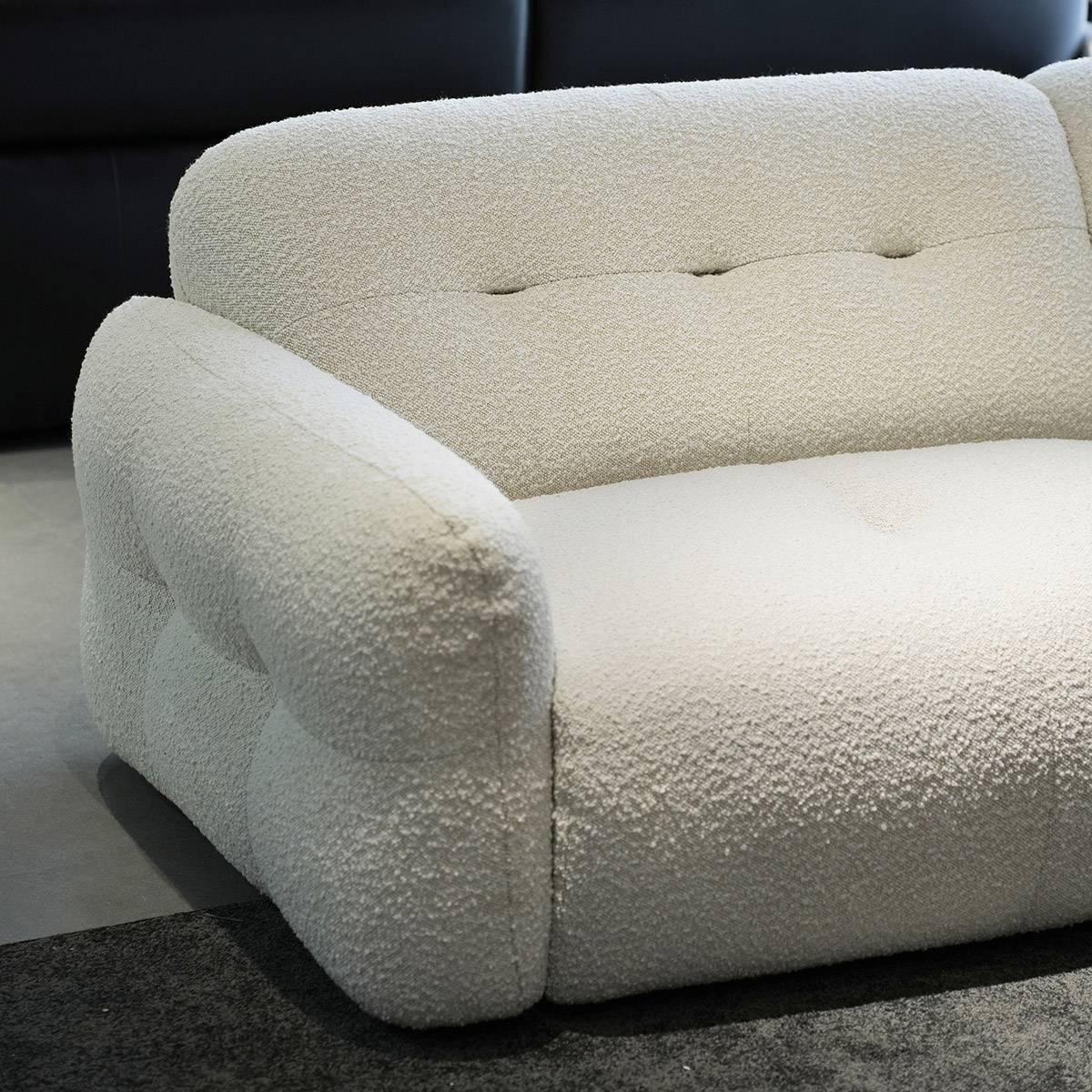 Close-up detail of the white fabric texture and armrest