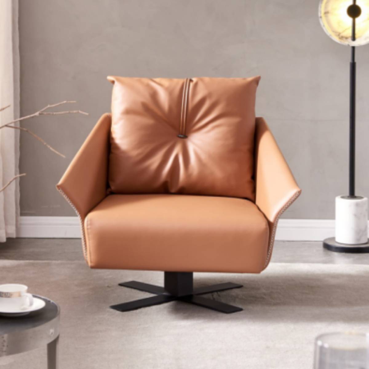 Front view of a tan suede leather lounge chair with a tufted back cushion