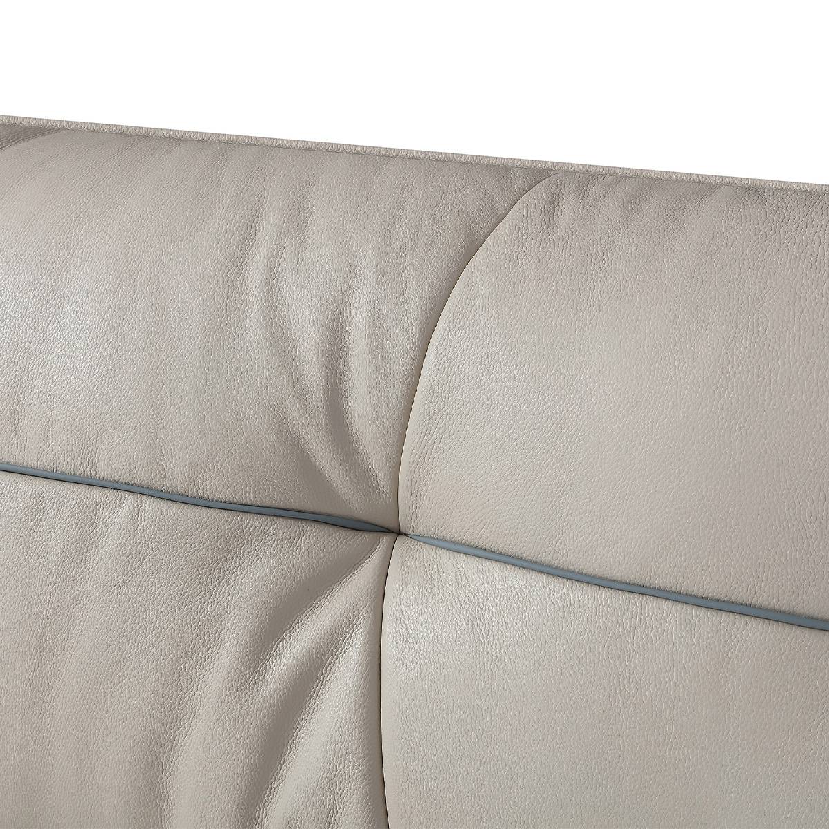 Close-up of the beige leather headboard texture and stitching