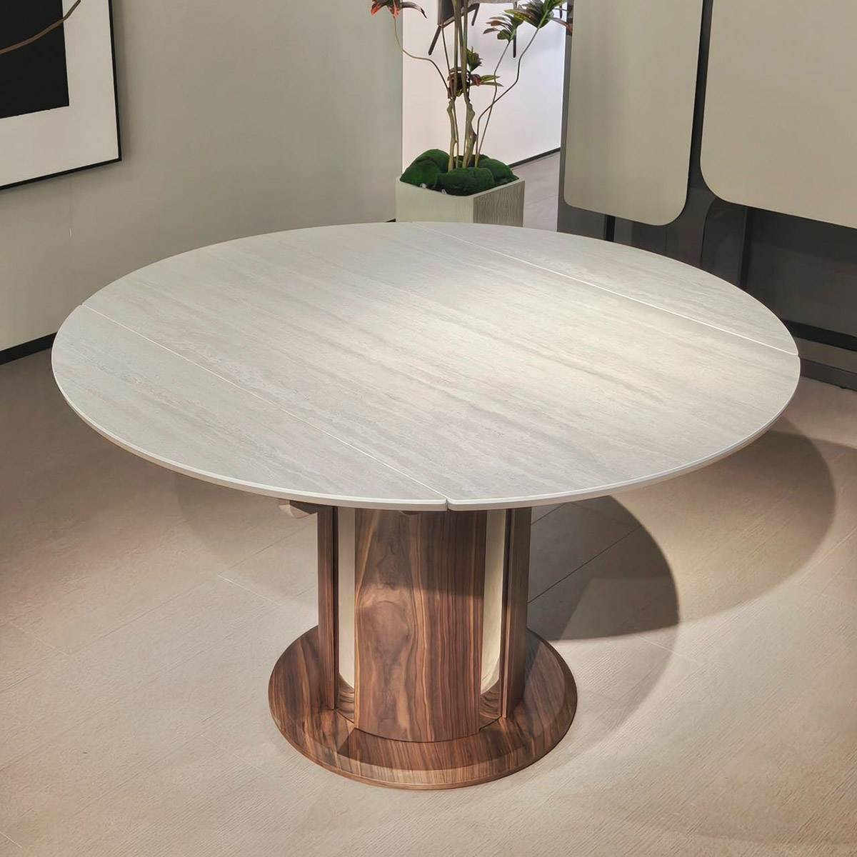 Close-up view of the round sintered stone dining table showing the wood grain base and stone texture