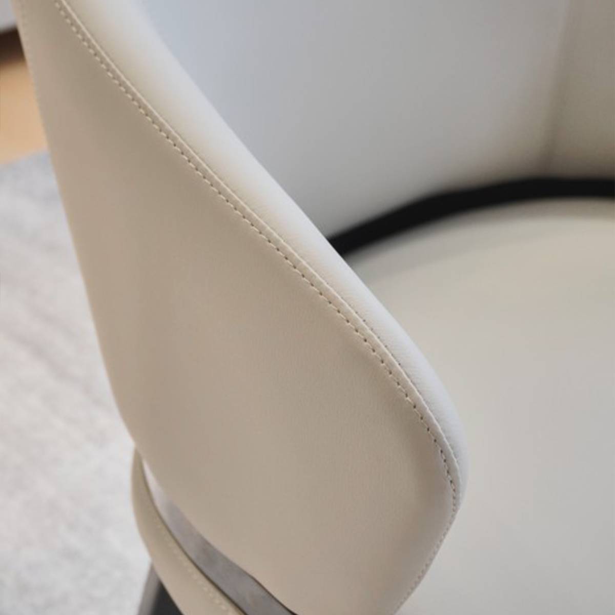 Close-up detail of the chair armrest stitching and upholstery