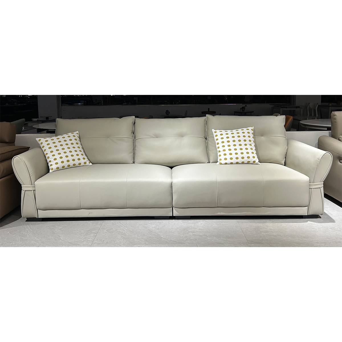 Front view of the beige straight sofa in a showroom setting