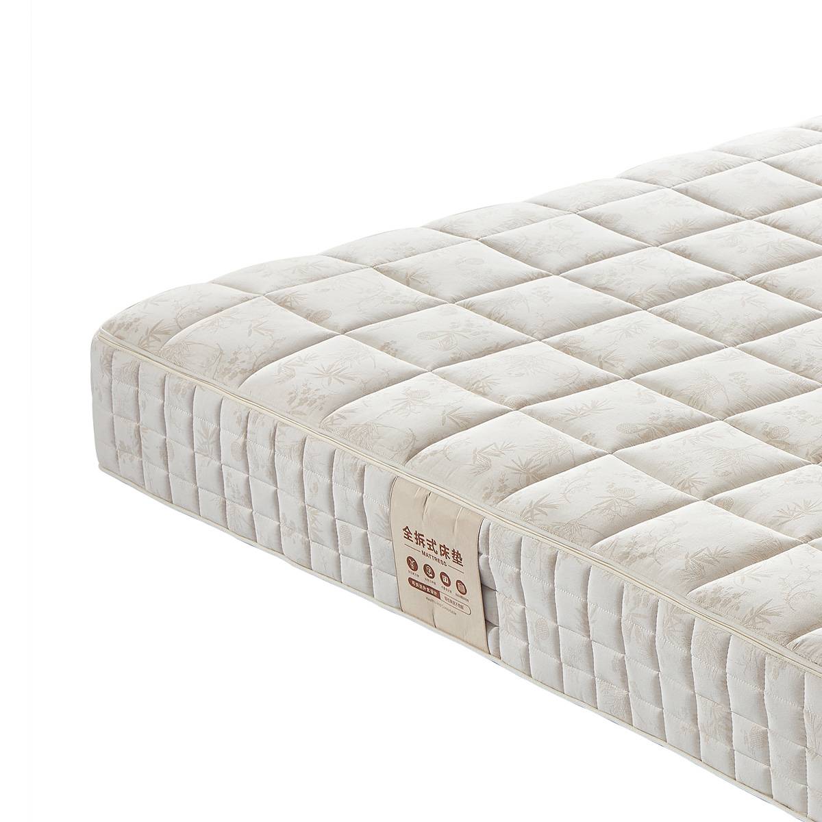 Close-up of the mattress corner showing the label and fabric texture