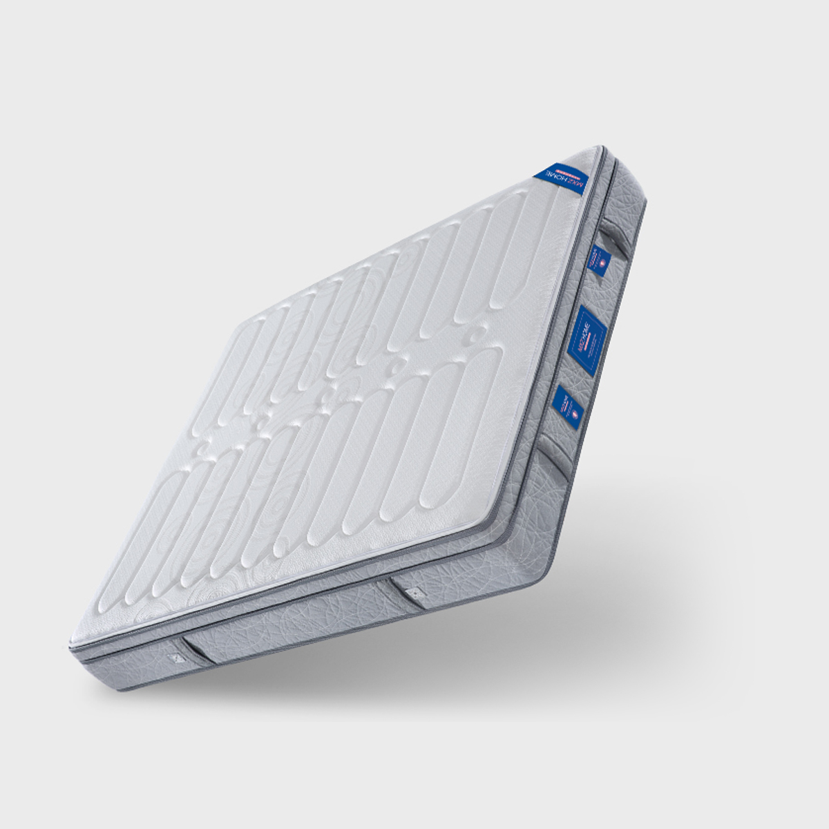 Angled view of the mattress showing the side profile and blue brand tags