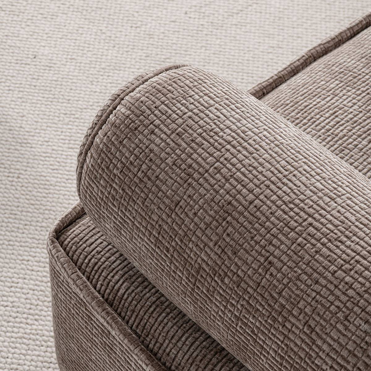 Detail shot of the fabric texture and stitching on the armrest