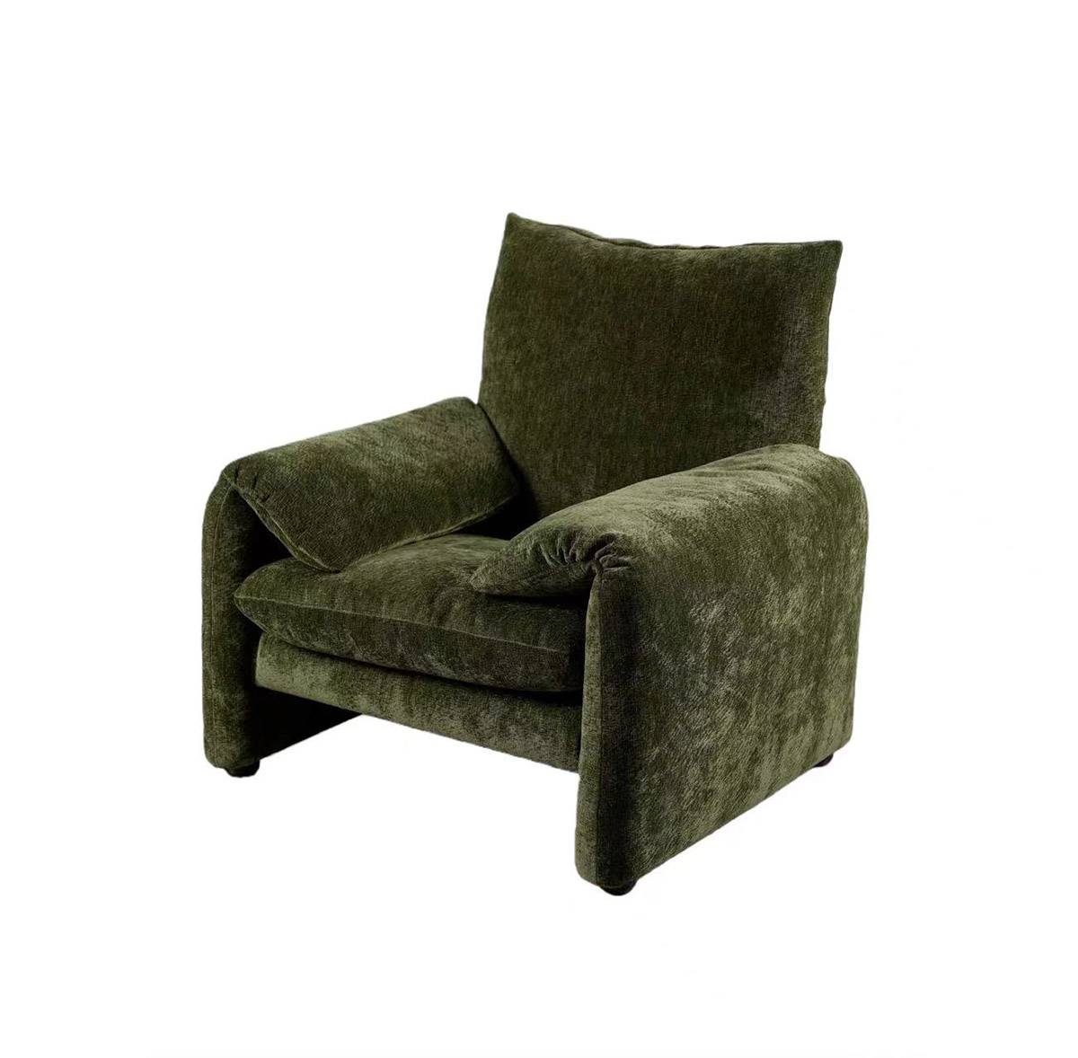 Three-quarter view of the green velvet lounge chair