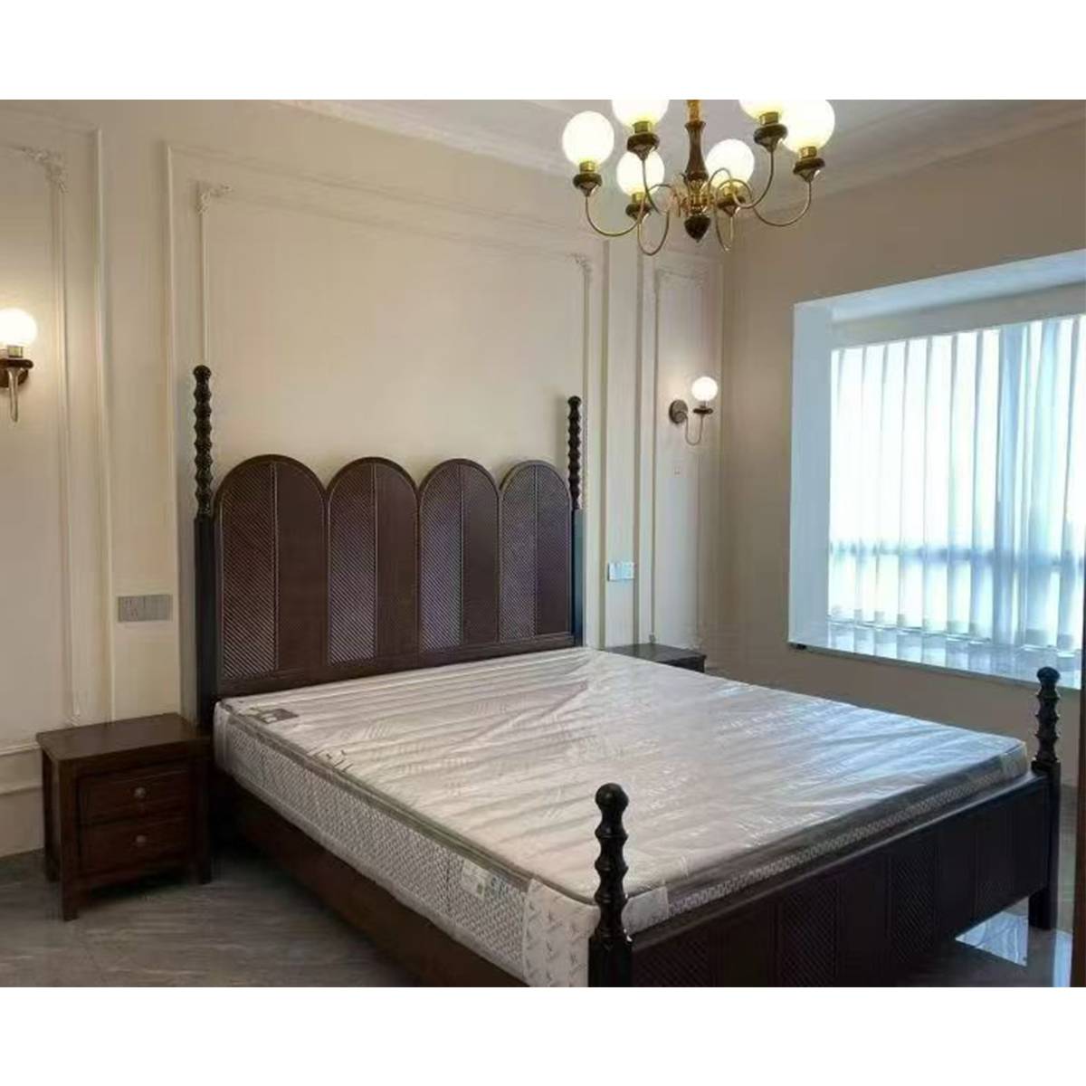 Bedroom setting with the bed, bedside table, and chandelier