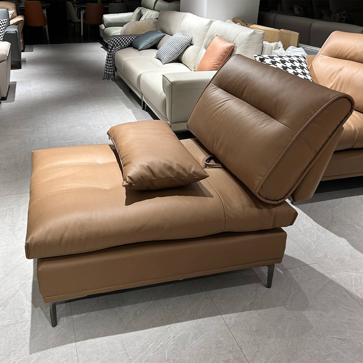 Close-up view of the brown leather sofa seat and backrest