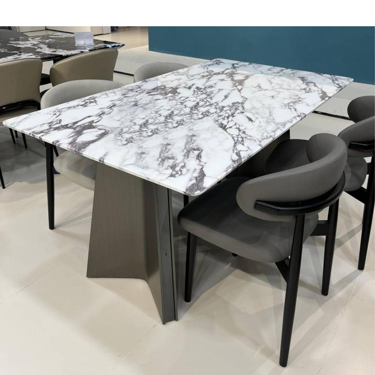 Front view of the marble dining table with grey chairs