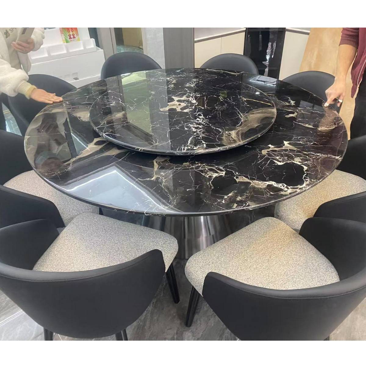 Close-up of the black marble dining table top showing the lazy susan and stone texture
