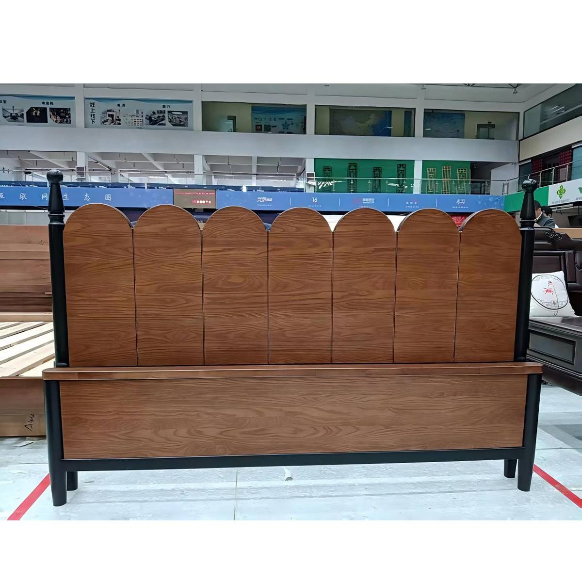 Close-up of the scalloped headboard and footboard wood grain