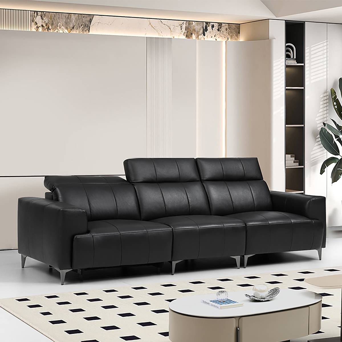 Side view of the black leather sofa showing adjustable headrests