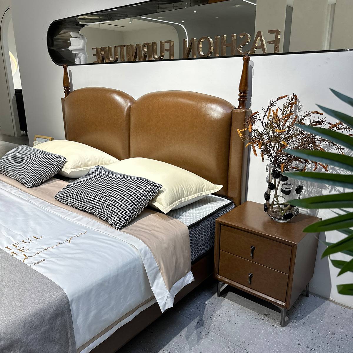 Close-up view of the bed headboard and side nightstand with dried flowers
