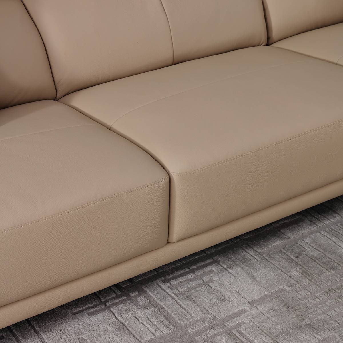 Close-up of beige leather sofa seat cushions