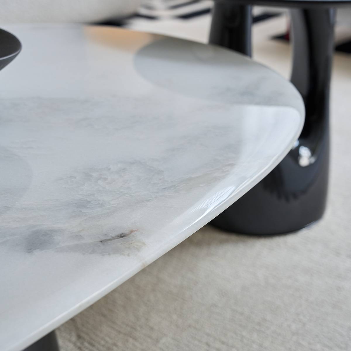 Close-up view of the white natural stone tabletop edge showing grey veining details