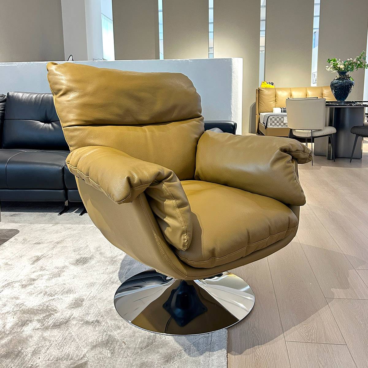 Angled view of tan leather swivel lounge chair