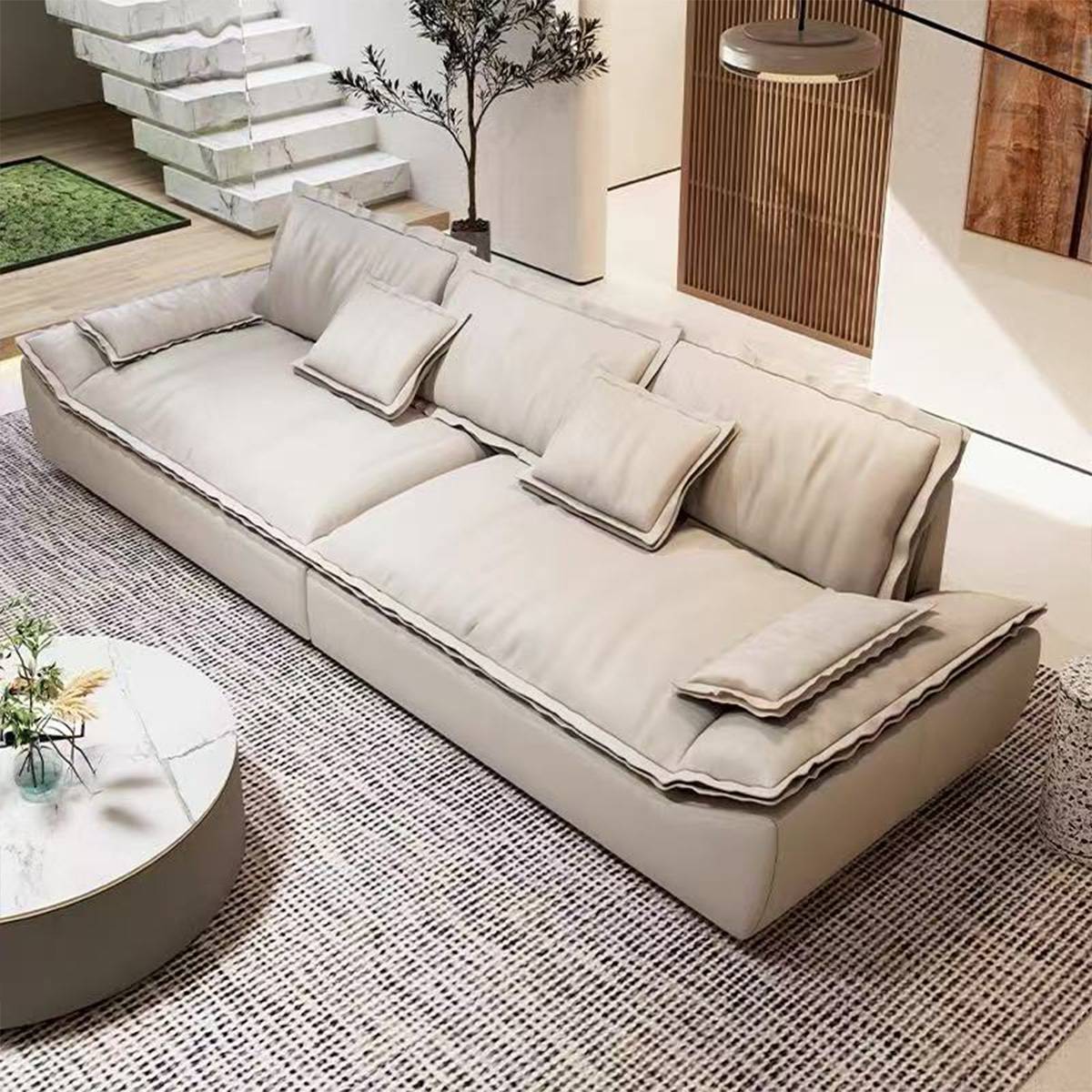 Angled view of a beige fabric version of the straight sofa with loose cushions.