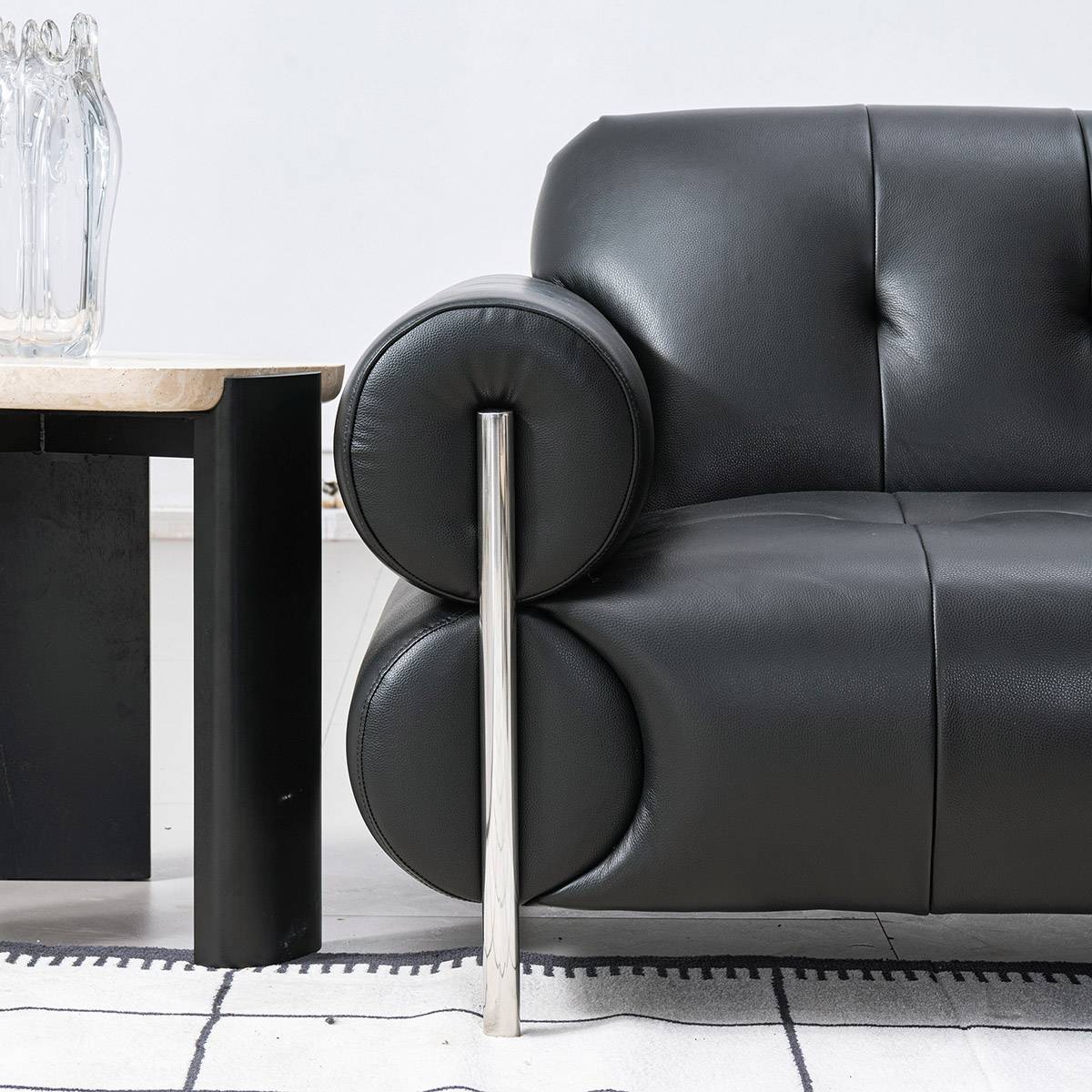Close-up of the sofa armrest and metal leg detail