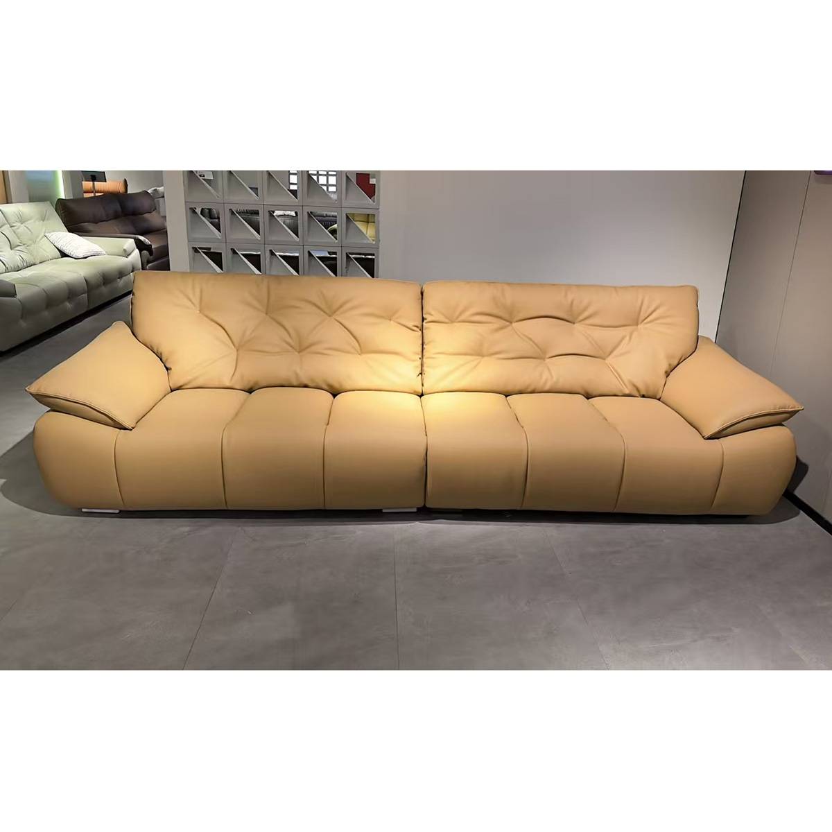 Tan leather straight row sofa with tufted backrest