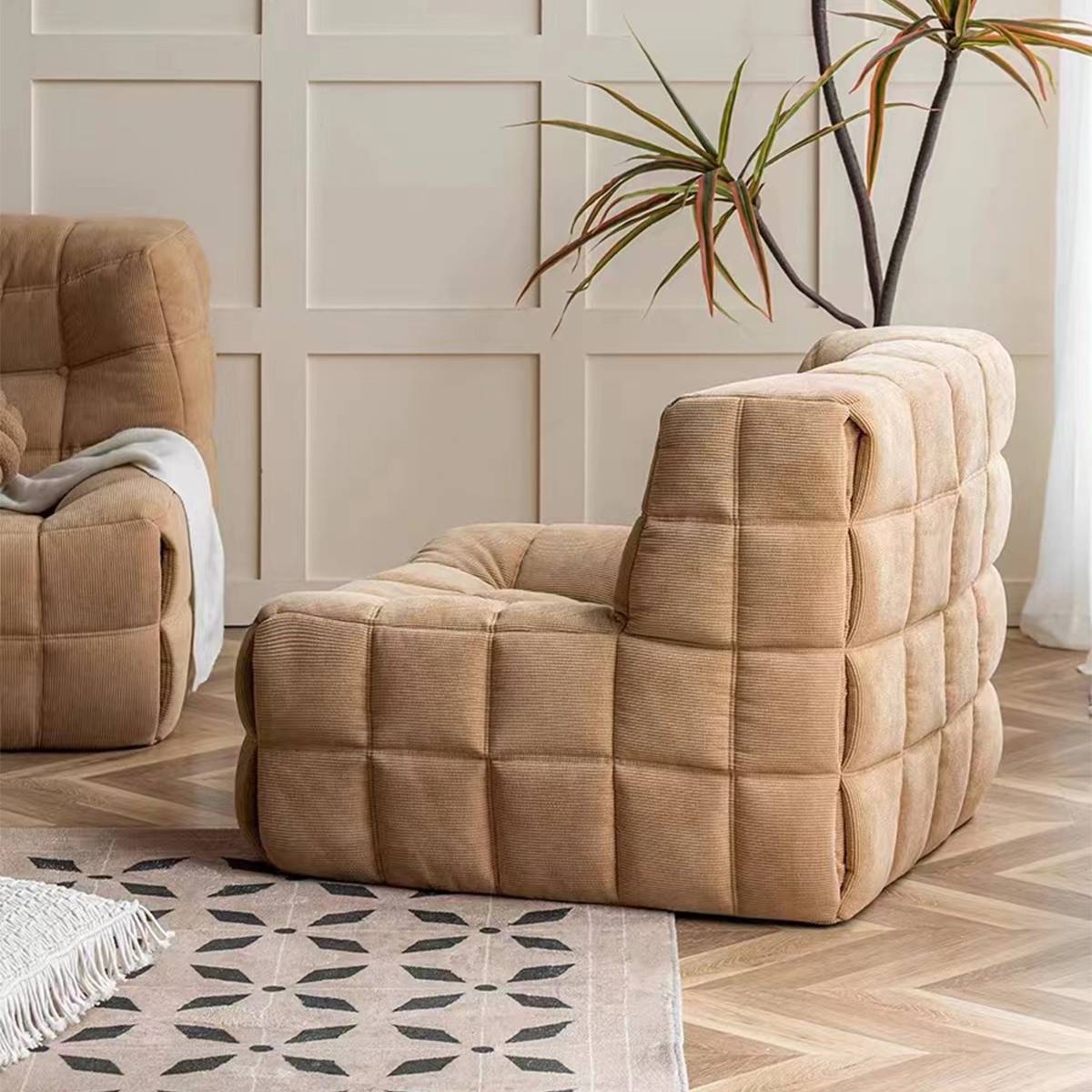 Beige waffle grid leisure chair in a living room setting