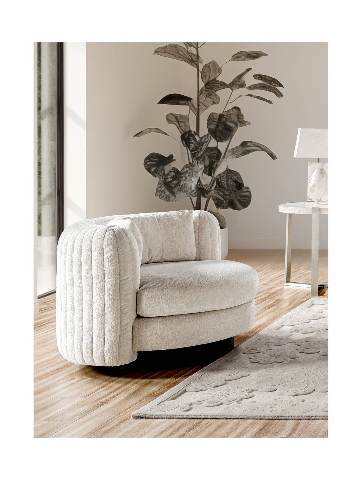 Side view of the white ribbed swivel lounge chair in a living room setting