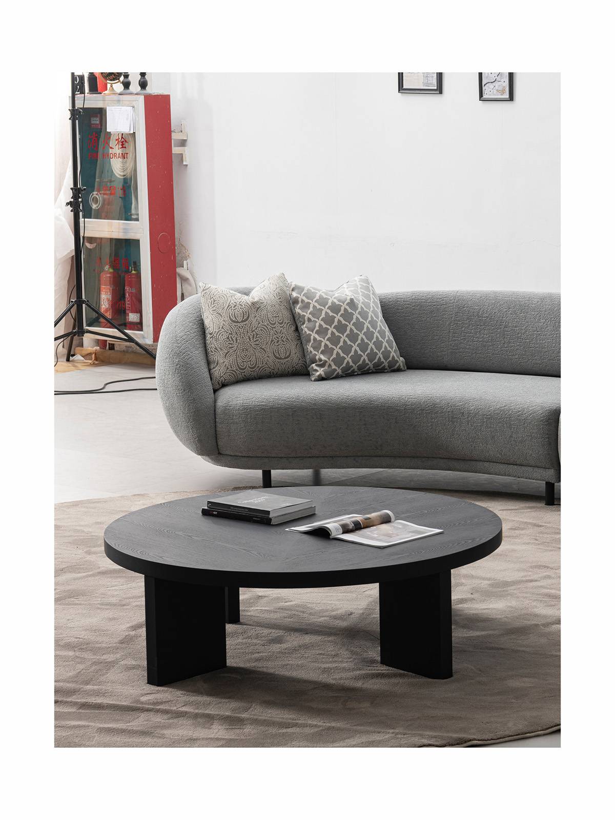 Lifestyle shot of a similar black round table in a living room setting