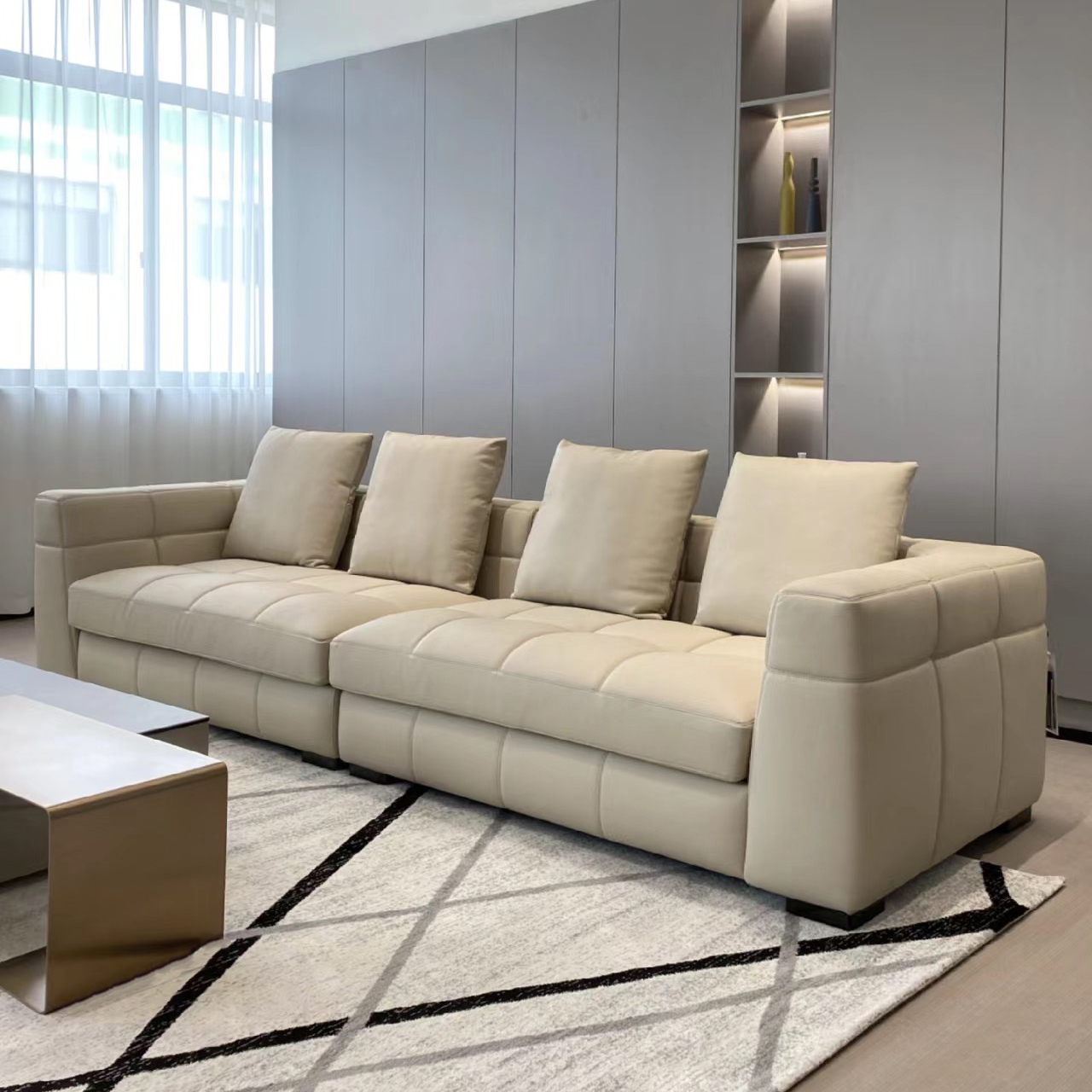 Beige leather modular sofa in a modern living room with geometric rug