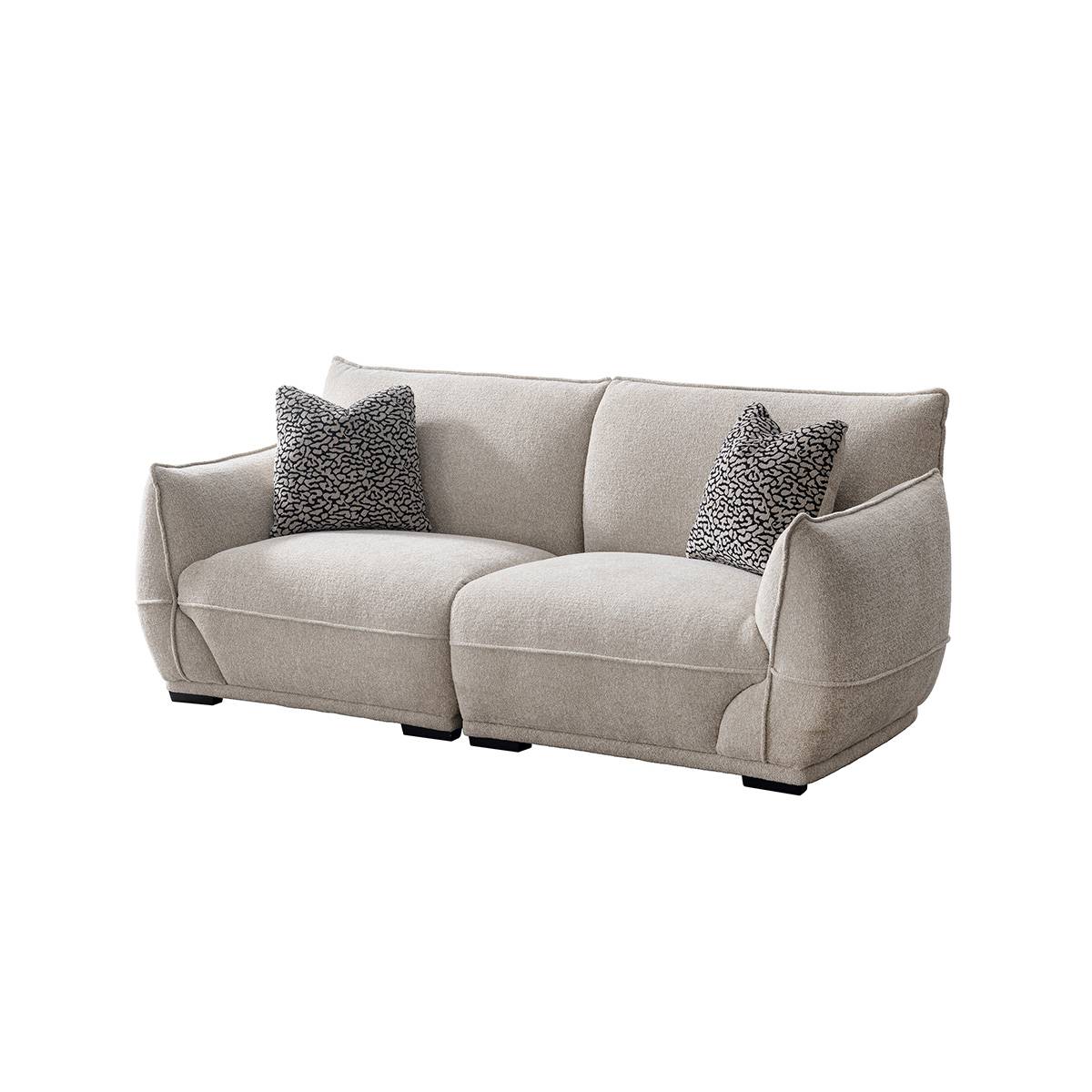 Light beige fabric sofa with patterned throw pillows