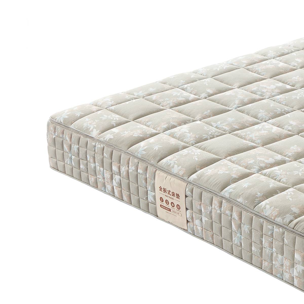 Close-up of the mattress corner showing the label and side quilting