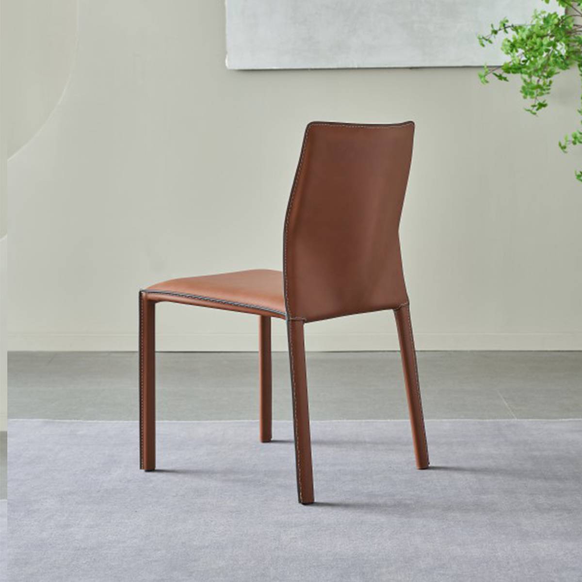 Rear view of a brown leather dining chair highlighting the stitching details