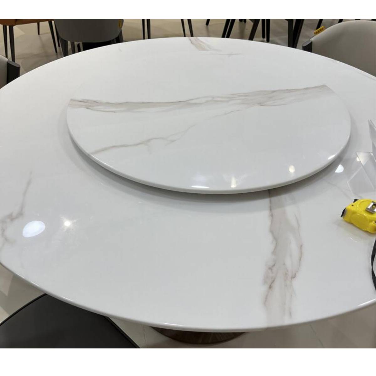Close-up of the white marble tabletop and rotating tray