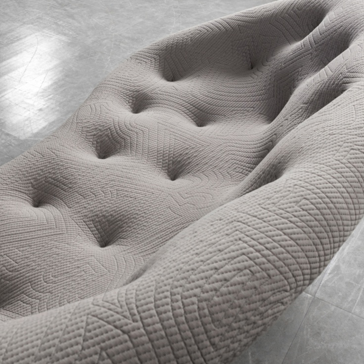 Side view of grey tufted sofa showing depth and texture