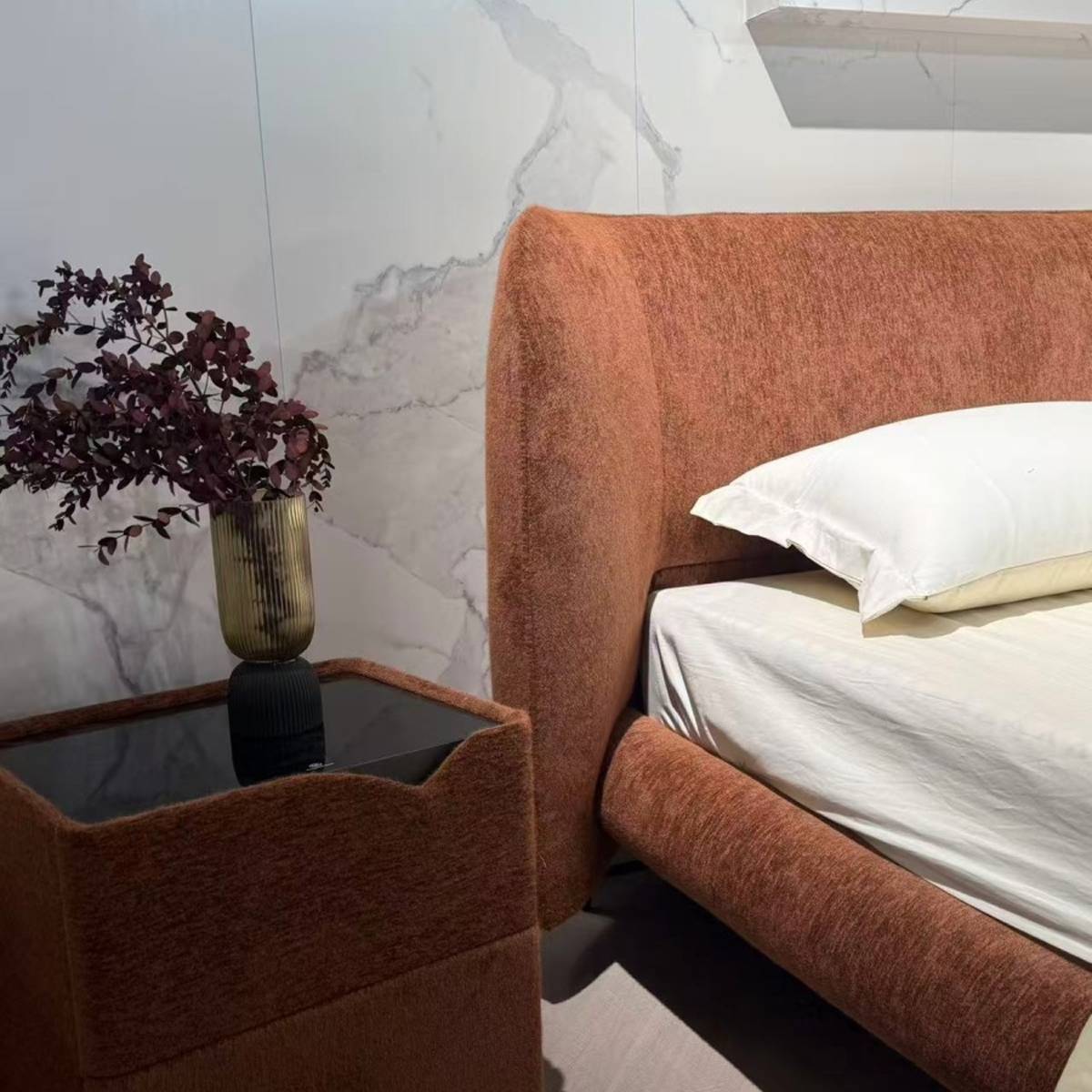Detail shot of the bedside table and the side of the bed headboard