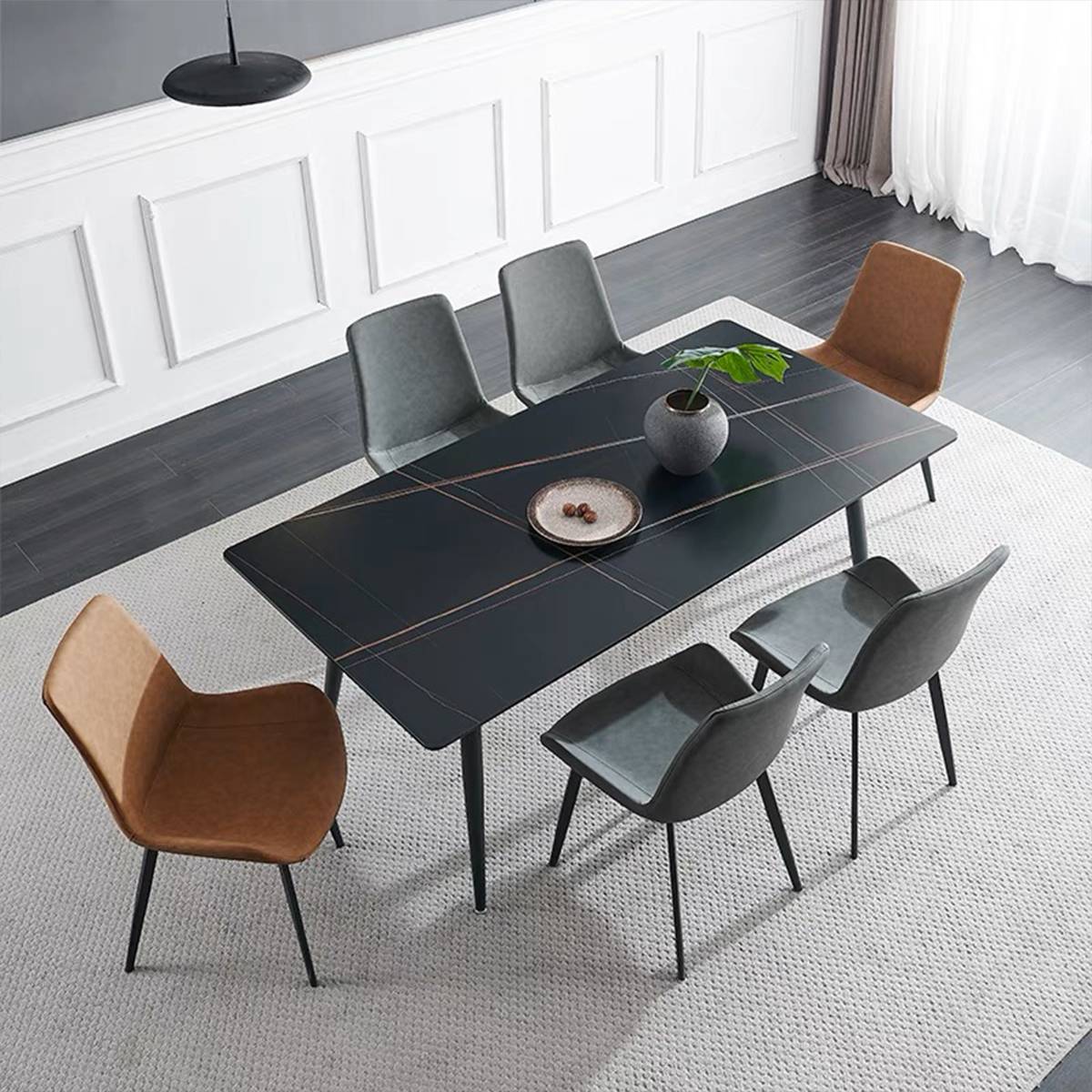 Black sintered stone dining table with grey and brown chairs