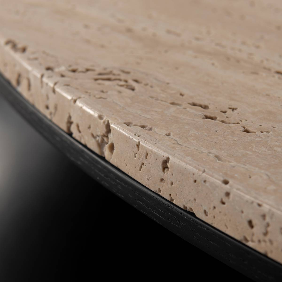 Close-up detail of the travertine stone edge showing natural texture and pores
