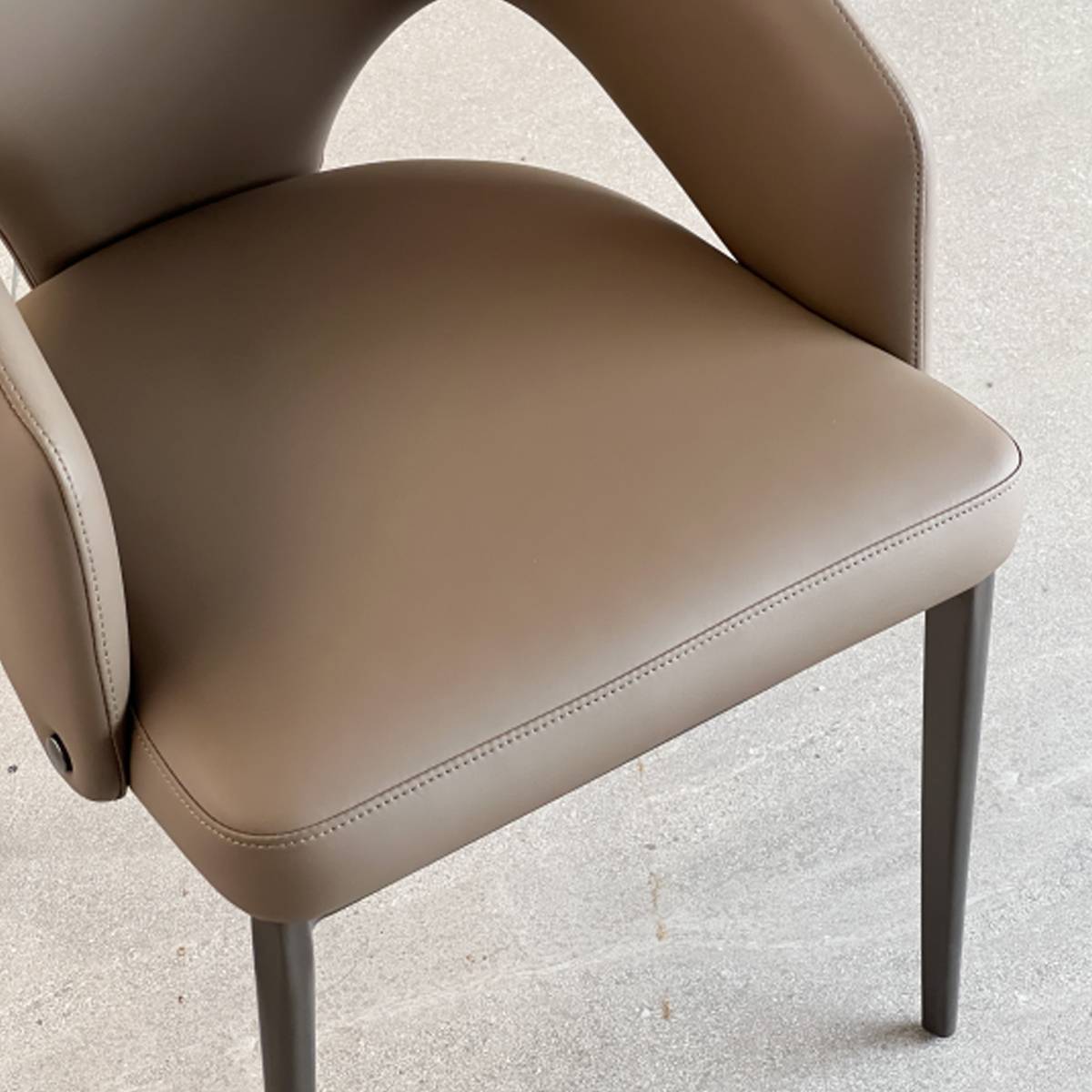 Close-up detail of the khaki leather seat and stitching