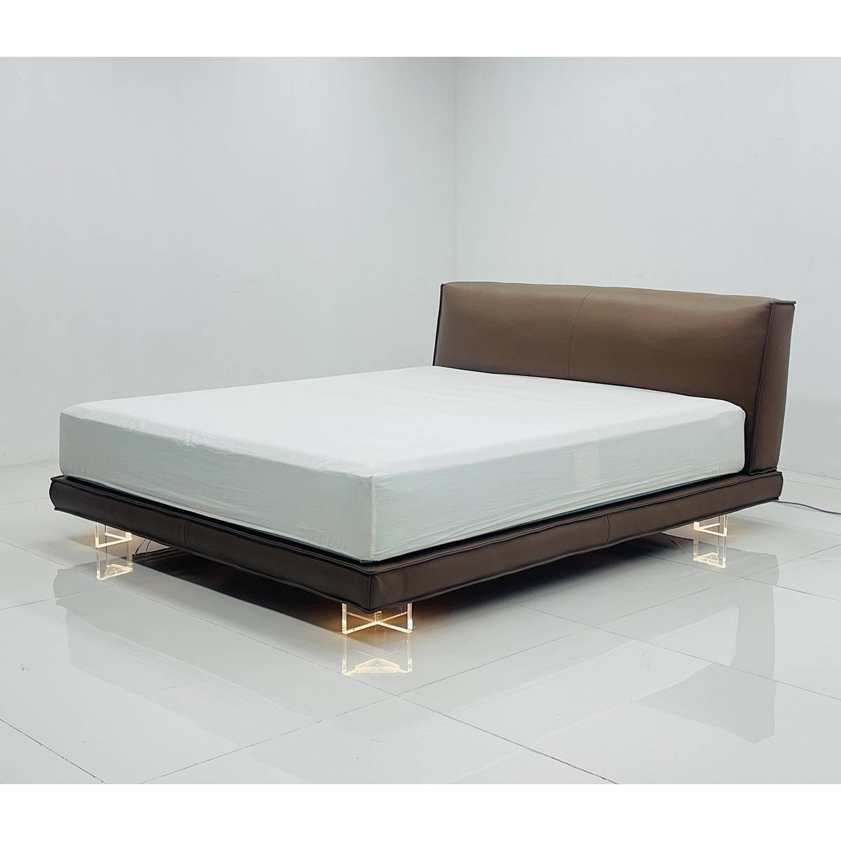 Side view of the leather bed showing the mattress and acrylic legs