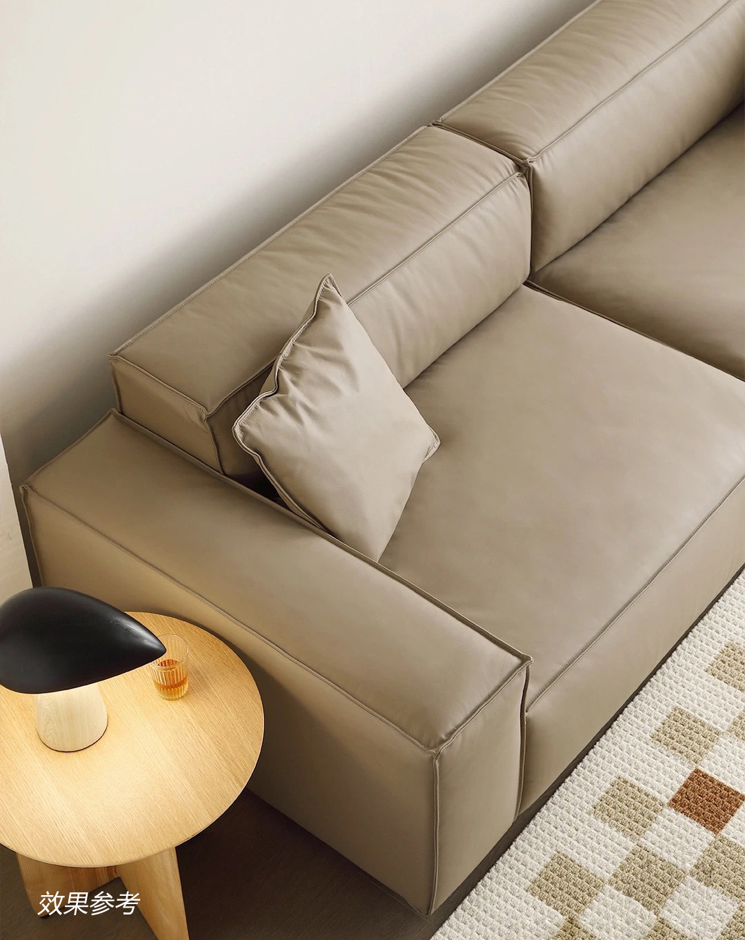 Beige leather sofa corner detail with pillow