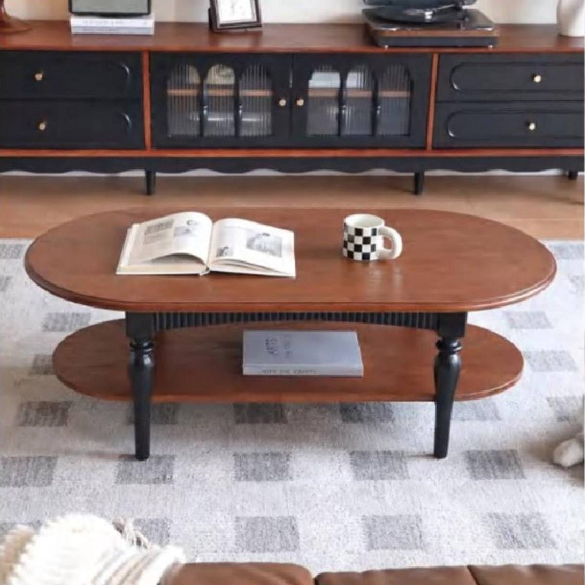 Front view of the coffee table placed in a living room setting with a matching sideboard in the background.