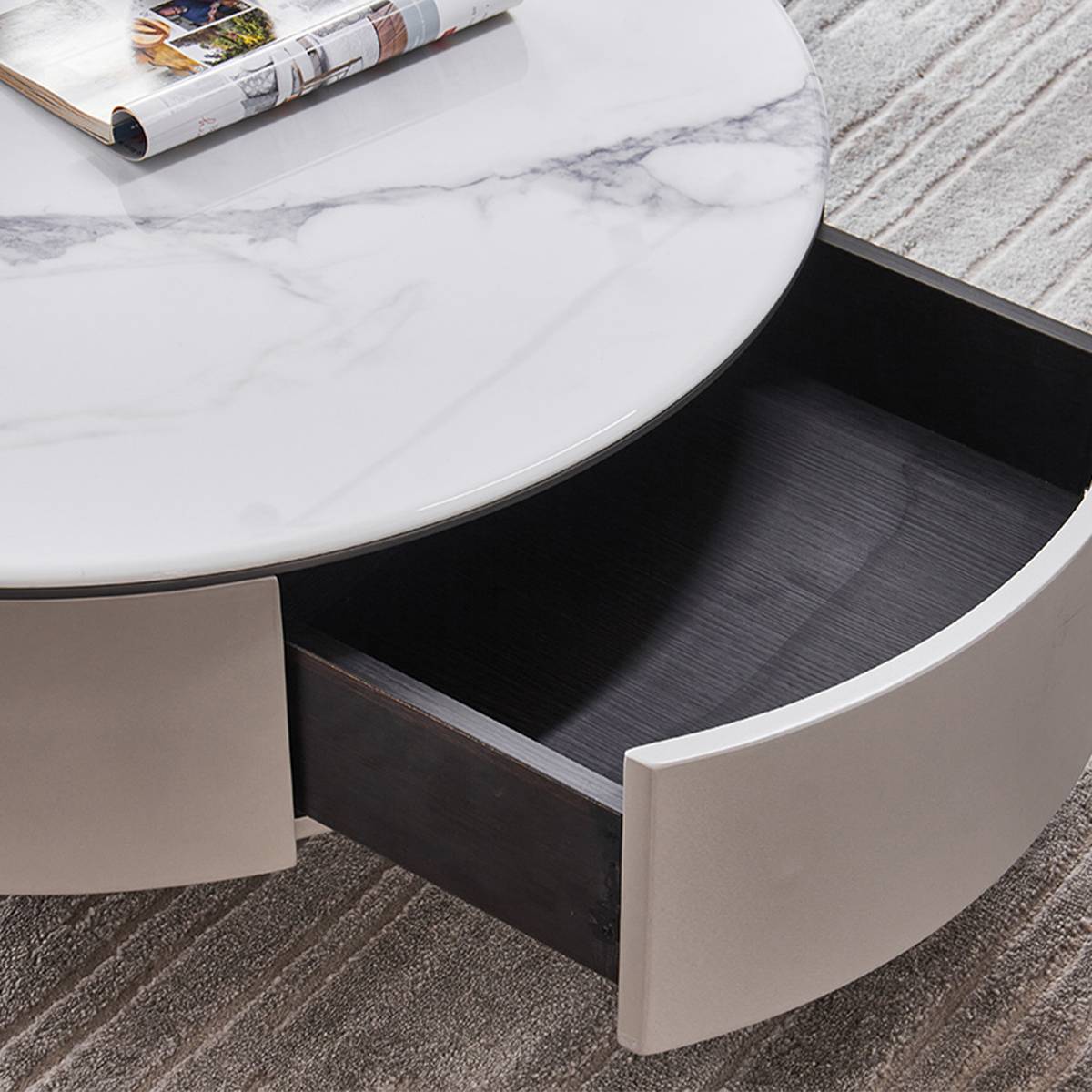 Close-up of the coffee table's open storage drawer showing the dark wood interior and marble-effect top.