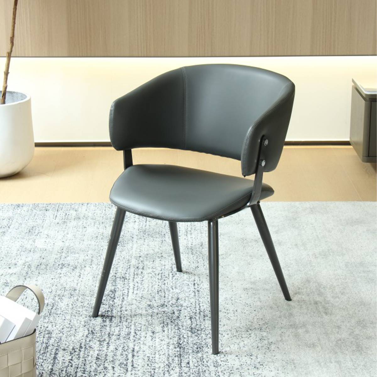Deep grey dining chair with carbon steel legs shown from a side angle